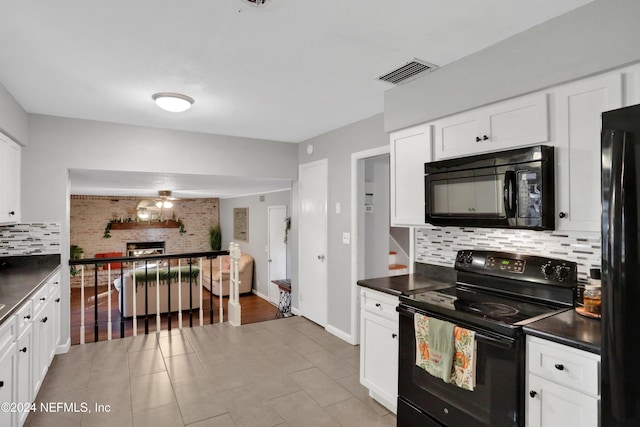 kitchen with black appliances, light tile patterned flooring, white cabinets, and backsplash