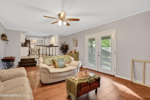 living room featuring ceiling fan, french doors, ornamental molding, and light wood-type flooring