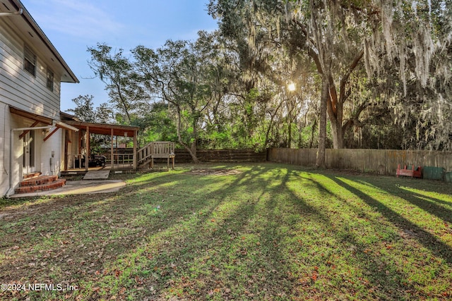 view of yard with a deck and a patio area