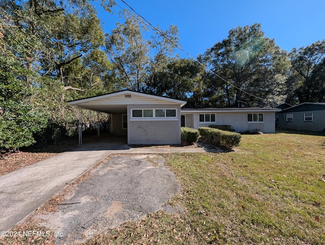 single story home featuring a carport and a front yard