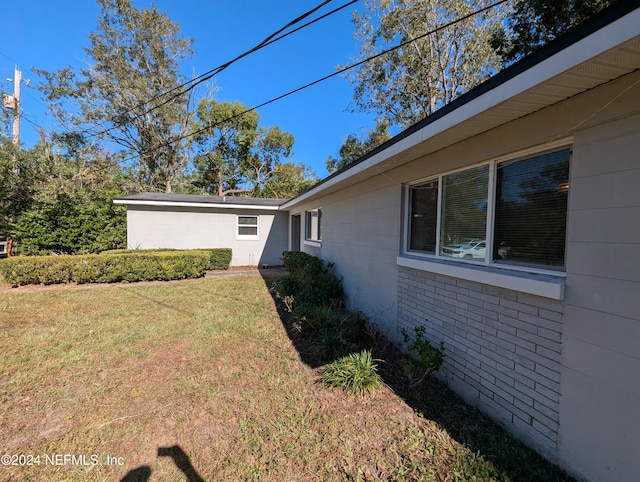 view of property exterior with a lawn