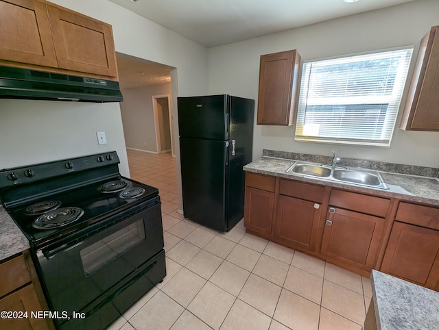 kitchen featuring sink, light tile patterned flooring, black appliances, and extractor fan