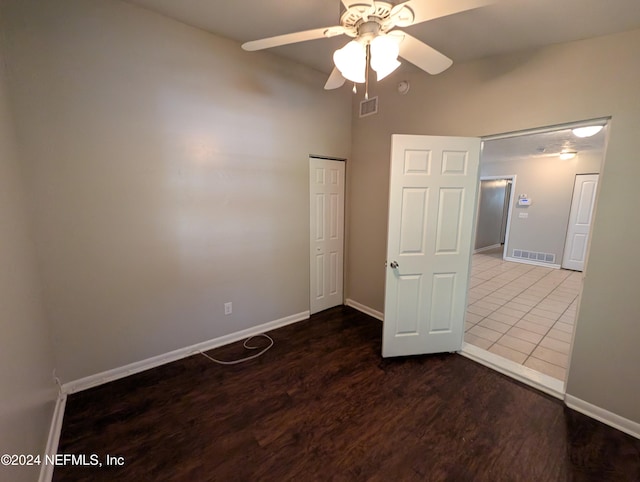 unfurnished bedroom featuring dark hardwood / wood-style floors and ceiling fan