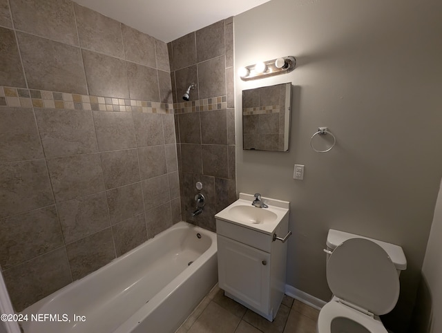 full bathroom featuring tile patterned floors, tiled shower / bath combo, toilet, and vanity