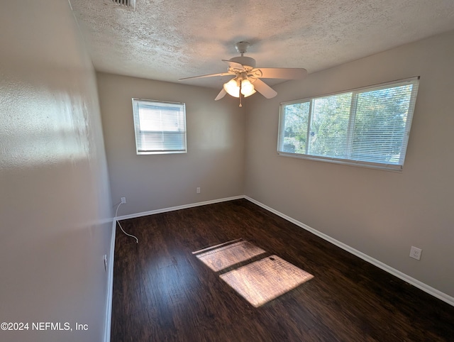 unfurnished room featuring a textured ceiling, dark hardwood / wood-style floors, and ceiling fan