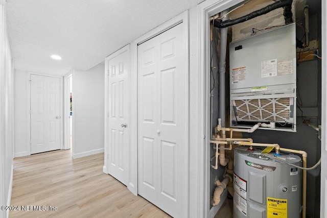 utility room with electric water heater