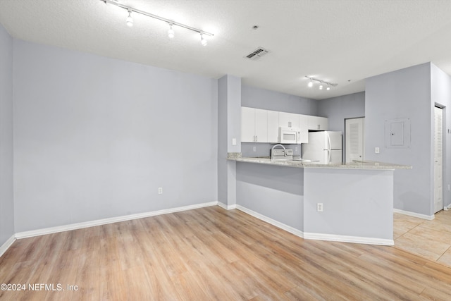 kitchen featuring white cabinets, white appliances, track lighting, and light hardwood / wood-style flooring