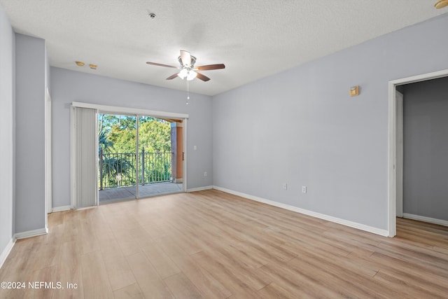 empty room featuring ceiling fan, light hardwood / wood-style floors, and a textured ceiling