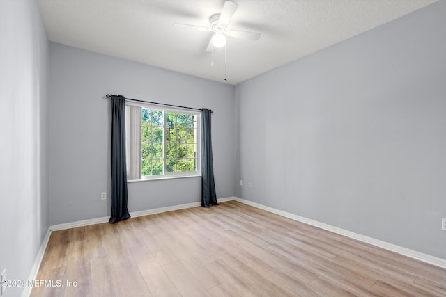 unfurnished room featuring ceiling fan, a textured ceiling, and light hardwood / wood-style flooring