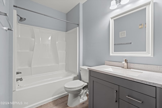 full bathroom featuring hardwood / wood-style floors, vanity, shower / bathtub combination, and toilet