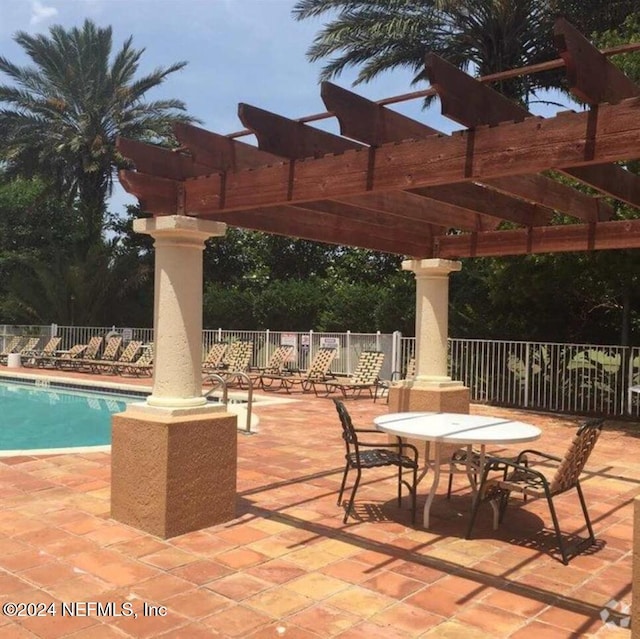 view of patio featuring a pergola and a community pool