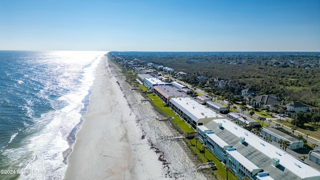 bird's eye view with a water view and a beach view