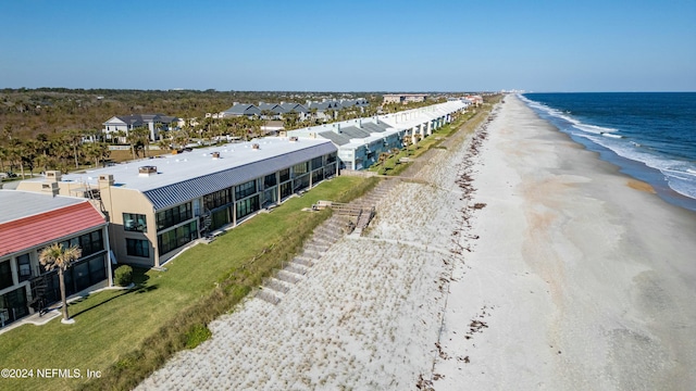 bird's eye view featuring a water view and a view of the beach