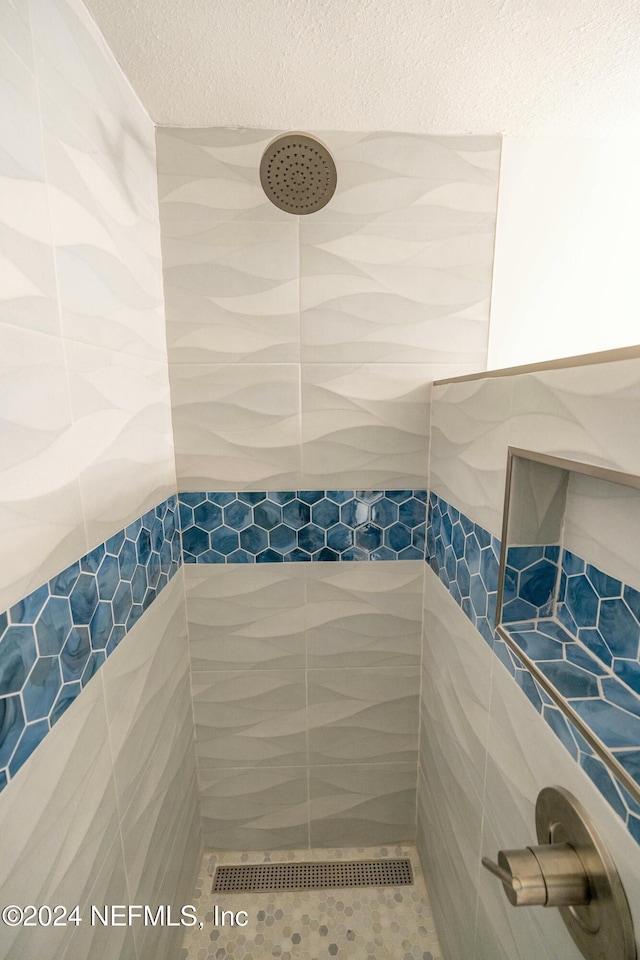 bathroom with a tile shower