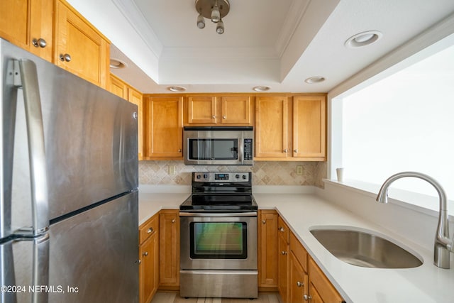 kitchen featuring crown molding, sink, appliances with stainless steel finishes, and tasteful backsplash