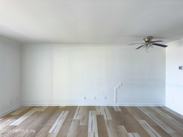 empty room with crown molding, ceiling fan, and light hardwood / wood-style floors