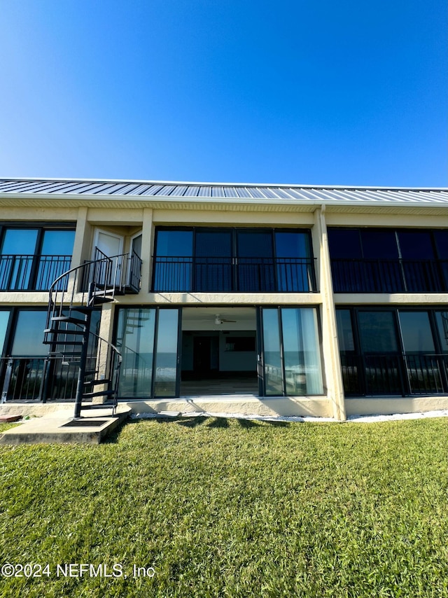 rear view of property with a lawn