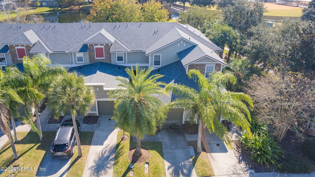 birds eye view of property with a water view