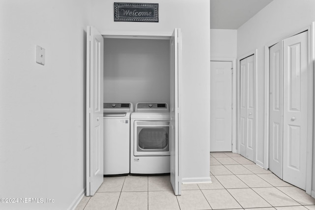 washroom featuring independent washer and dryer and light tile patterned floors