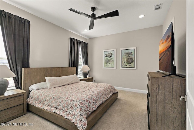 bedroom with ceiling fan and light carpet