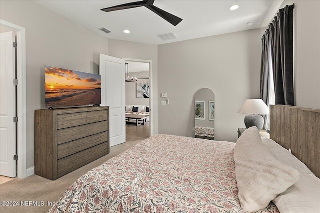 bedroom with ceiling fan with notable chandelier