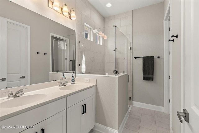 bathroom with tile patterned flooring, vanity, and tiled shower