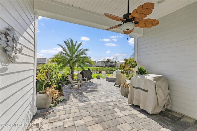 view of patio featuring ceiling fan and a grill