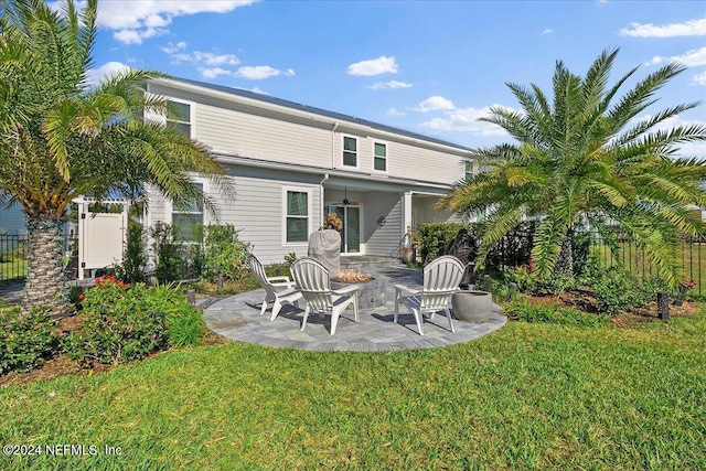 rear view of house with a lawn, a patio area, and ceiling fan