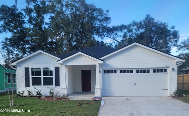 view of front of home featuring a garage and a front lawn