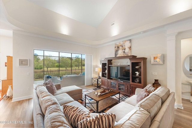 living room with high vaulted ceiling and light wood-type flooring