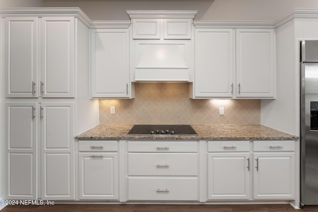 kitchen featuring white cabinets, black electric cooktop, and custom exhaust hood