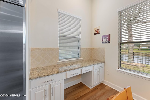 interior space with backsplash and wood-type flooring