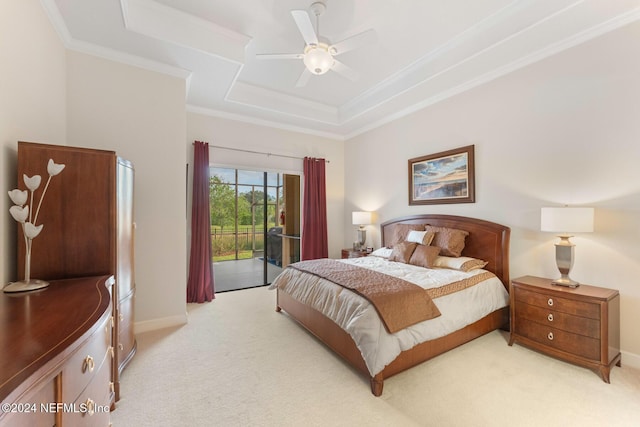 carpeted bedroom with access to outside, crown molding, ceiling fan, and a tray ceiling