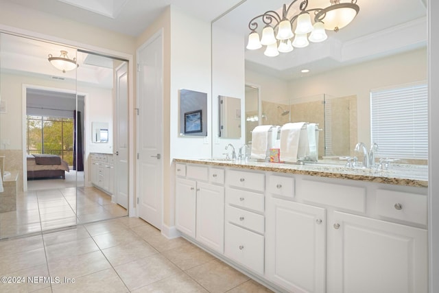 bathroom featuring tile patterned flooring, vanity, and a shower with door