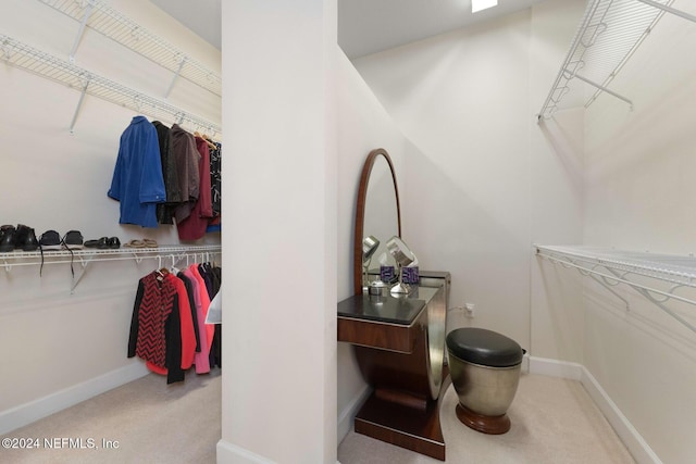 spacious closet with light colored carpet