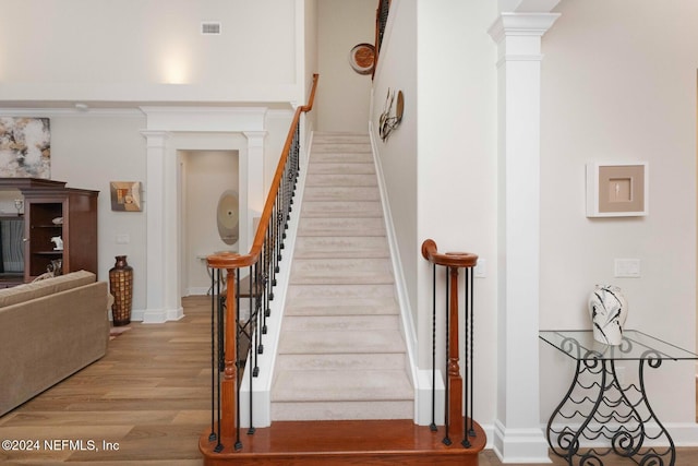 staircase with hardwood / wood-style floors