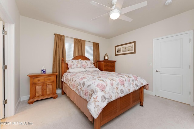 bedroom with ceiling fan and light colored carpet