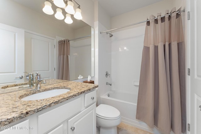 full bathroom with tile patterned floors, shower / bath combo with shower curtain, vanity, and toilet