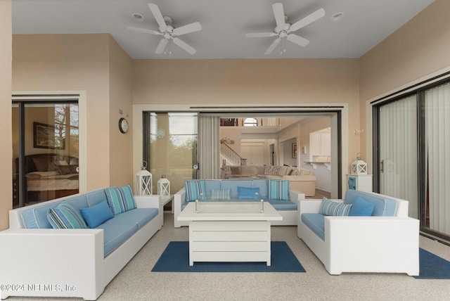 carpeted living room featuring ceiling fan