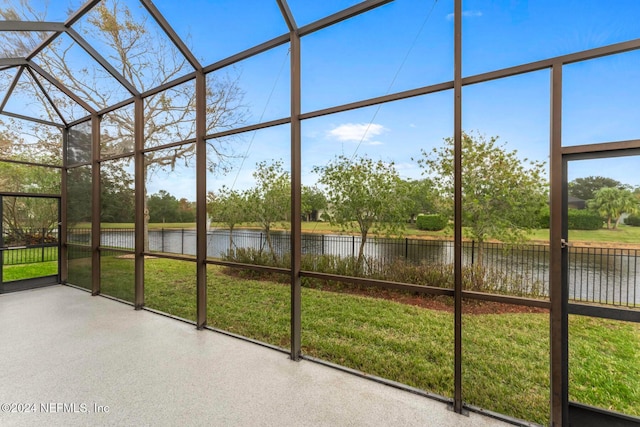 unfurnished sunroom with a water view