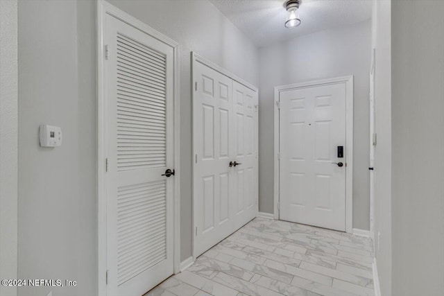 interior space with a textured ceiling