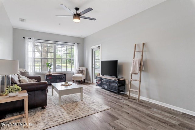 living room featuring ceiling fan and wood-type flooring