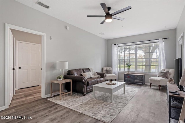 living room with hardwood / wood-style floors and ceiling fan