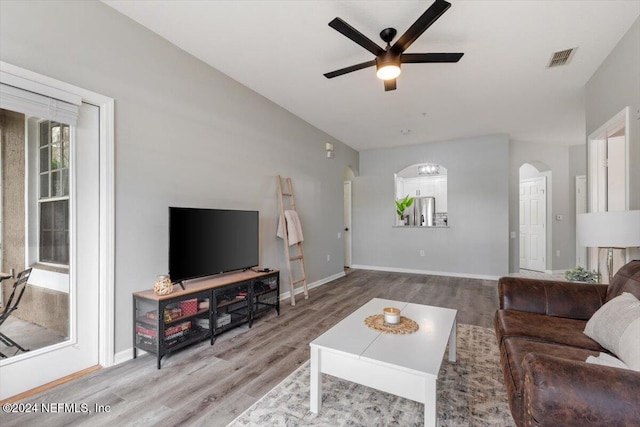 living room with wood-type flooring and ceiling fan