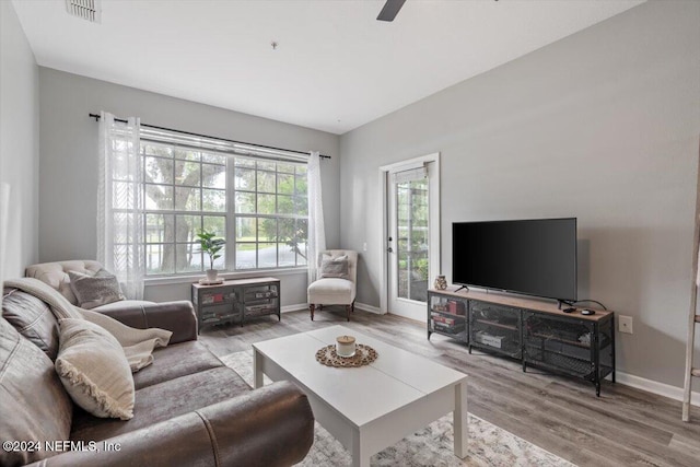 living room featuring ceiling fan and light hardwood / wood-style floors