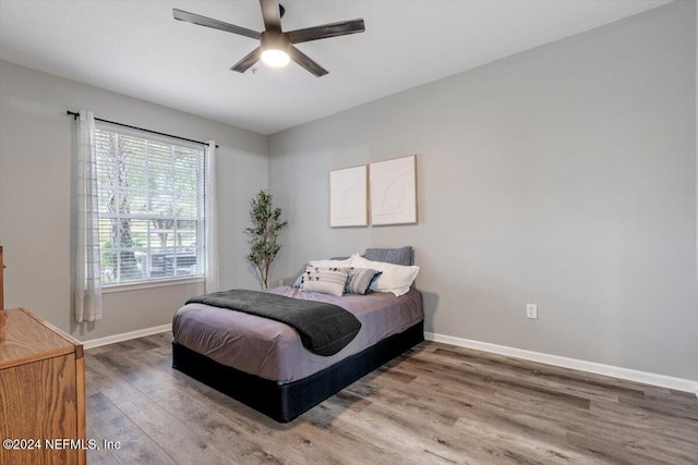 bedroom with ceiling fan and wood-type flooring