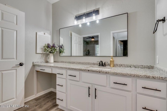 bathroom featuring ceiling fan, vanity, and wood-type flooring