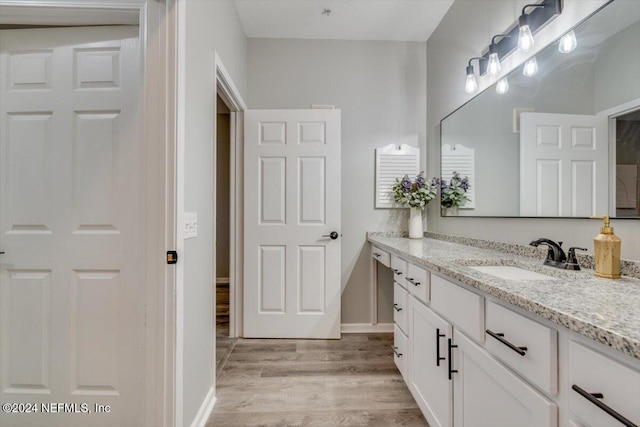 bathroom featuring hardwood / wood-style floors and vanity