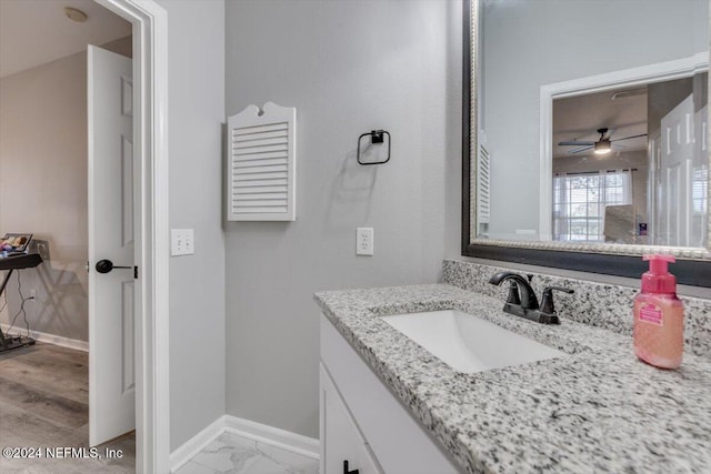 bathroom with hardwood / wood-style floors, vanity, and ceiling fan