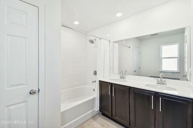 bathroom with tile patterned floors, vanity, and shower / tub combo